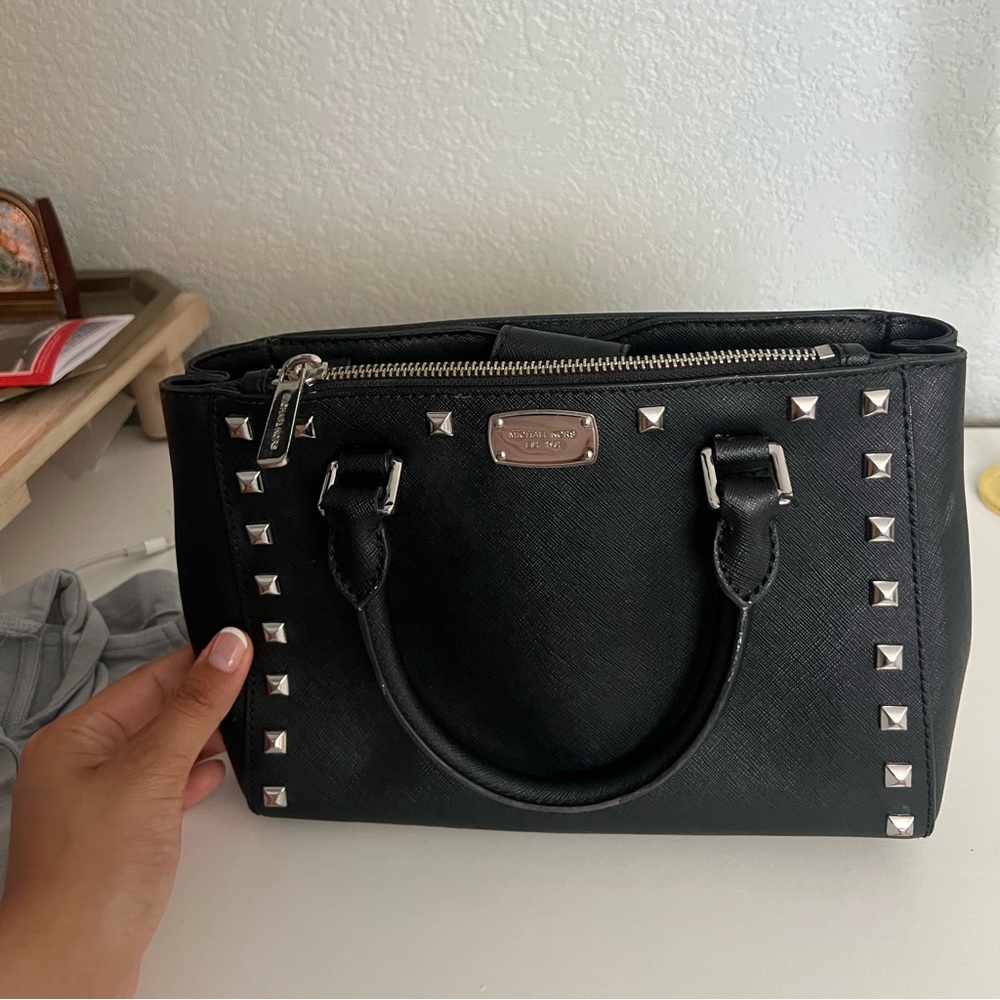 Michael Kors, black purse with a strap shoulder strap